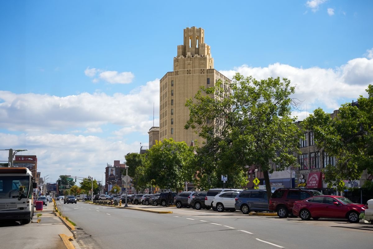 Main Avenue at street level, with the median parking lot and the Passaic tower in the background.